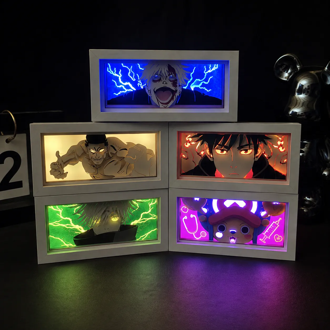 3D paper cut light boxes with layered artwork and colored backlighting